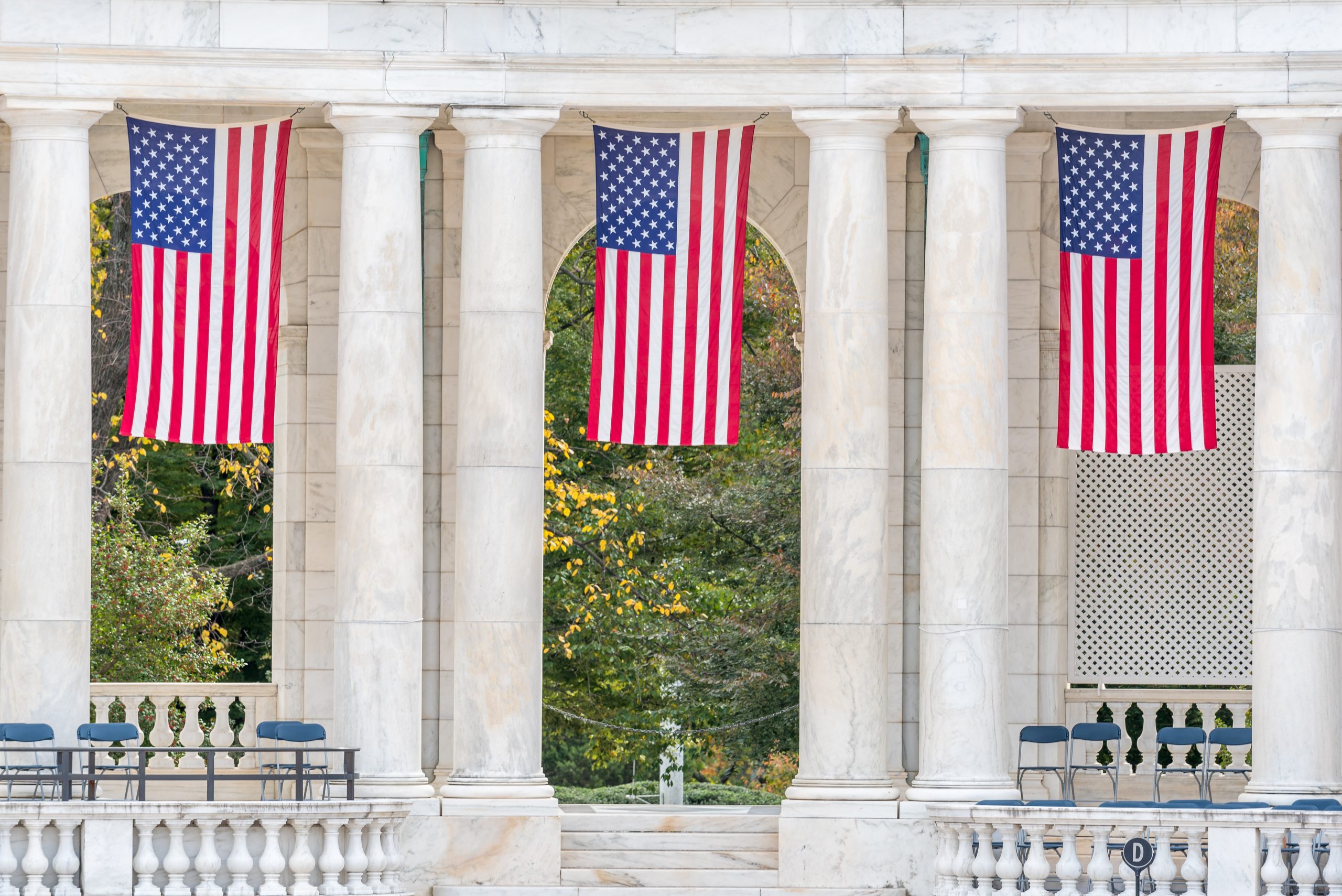 Memorial Amphitheatre, Arlington National Cemetery, Virginia, USA with hanging US Stars and Stripes flags